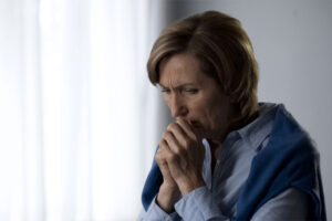 image of a woman dealing with cold air leaks at home