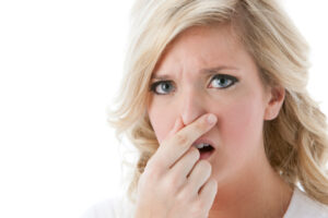 image of a woman smelling furnace odors