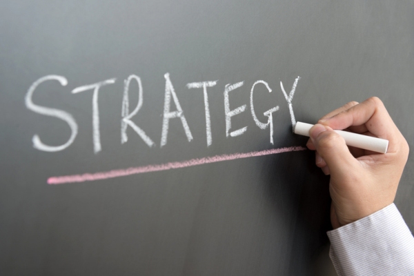 Strategy written on a chalkboard depicting carbon management