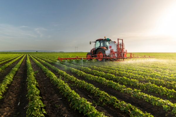 tractor watering soy field depicting agriculture and food security