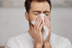 image of homeowner with allergies dealing with dry air in winter