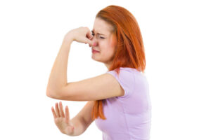 image of a homeowner plugging nose because furnace smells like heating oil