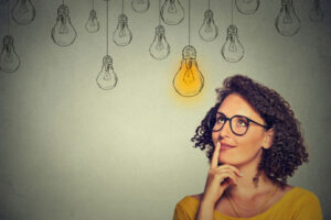 image of a woman with light bulb depicting decision about automatic vs will call propane delivery