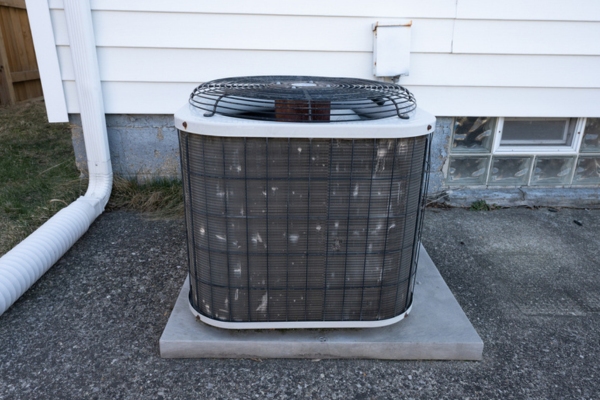 old residential air conditioner depicting dirty or clogged condenser