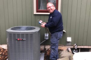 Wilcox Energy professional HVAC technician checking air conditioner