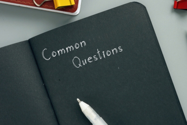 common questions written on a black notebook depicting FAQs about furnace replacement